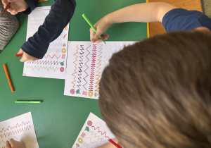 Dzieci wypełniają kartę pracy.